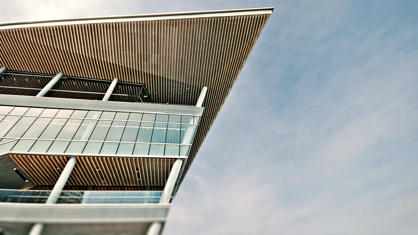 Modern building with a wide timber roof overhang and glass floors